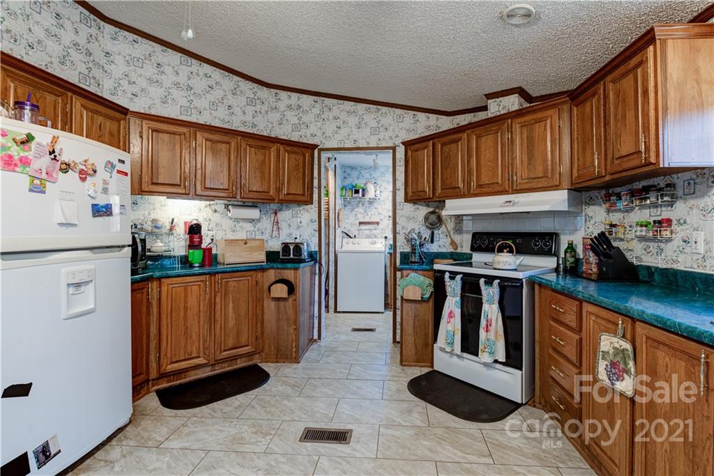 184 Terrys Gap Loop Road Fletcher, NC 28732 - Photo 8 of 28 a kitchen with stainless steel appliances granite countertop a refrigerator and a stove top oven