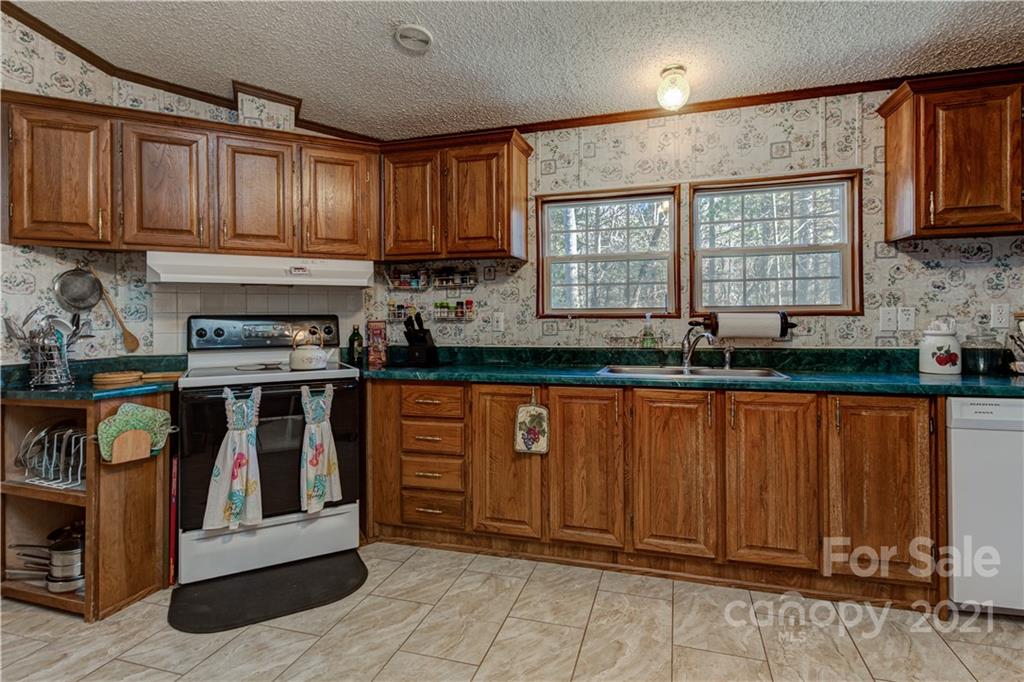 184 Terrys Gap Loop Road Fletcher, NC 28732 - Photo 9 of 28 a kitchen with granite countertop stainless steel appliances a sink cabinets and a window