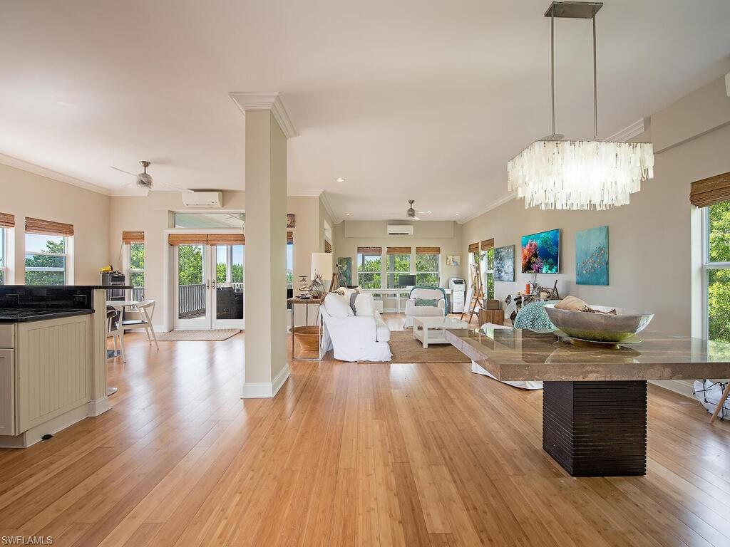 a living room with fireplace furniture and a chandelier