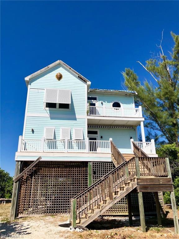 11231 Keewaydin Island Naples, FL 34113 - Photo 13 of 27 a view of a brick building with many windows