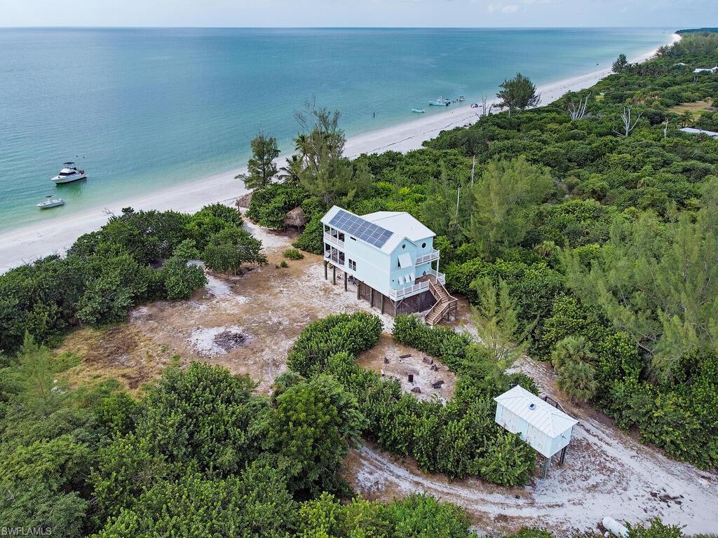 11231 Keewaydin Island Naples, FL 34113 - Photo 23 of 27 an aerial view of a house with a yard and lake view
