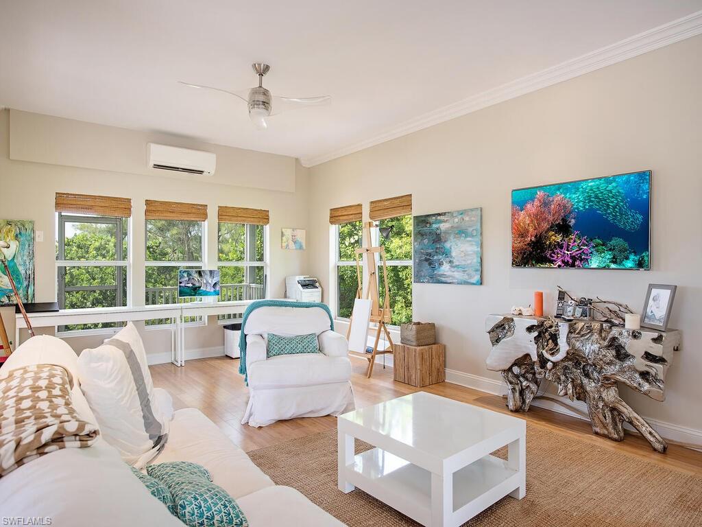 11231 Keewaydin Island Naples, FL 34113 - Photo 3 of 27 a living room with furniture and a flat screen tv