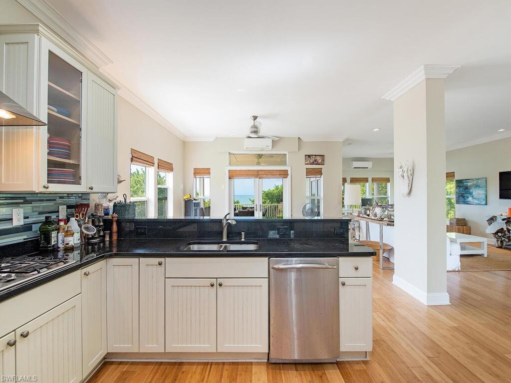 11231 Keewaydin Island Naples, FL 34113 - Photo 5 of 27 a kitchen with granite countertop a sink and cabinets