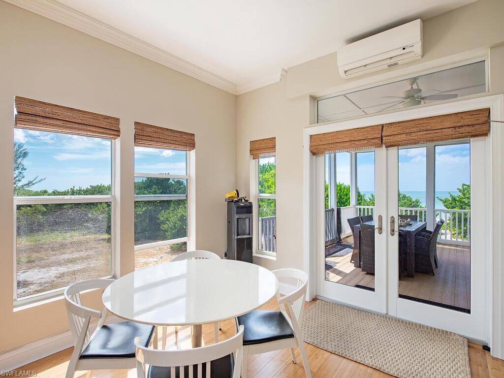 11231 Keewaydin Island Naples, FL 34113 - Photo 6 of 27 a living room with a large window and a table