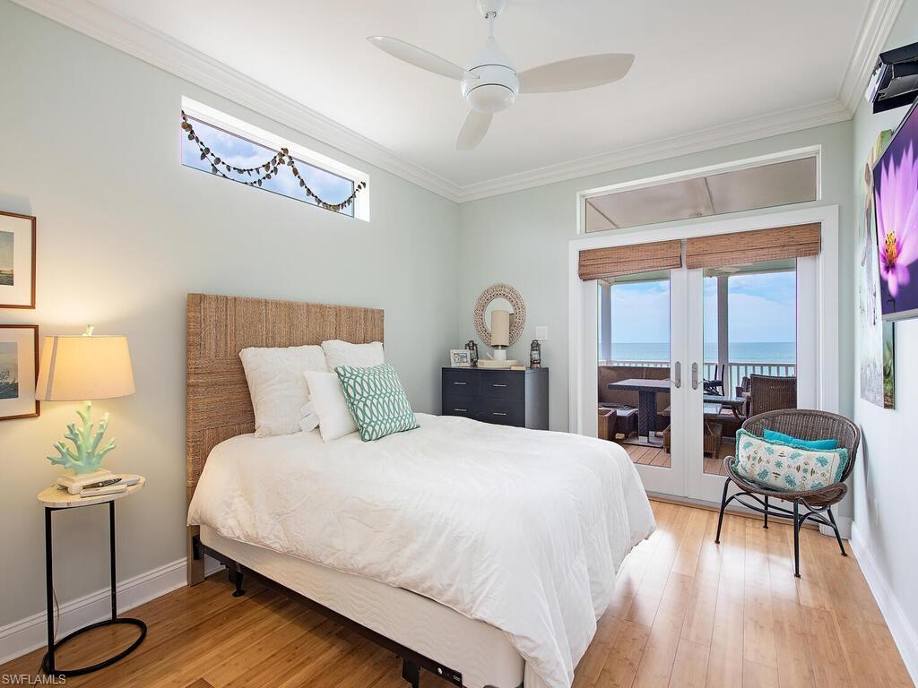 11231 Keewaydin Island Naples, FL 34113 - Photo 8 of 27 a bedroom with a bed and a table