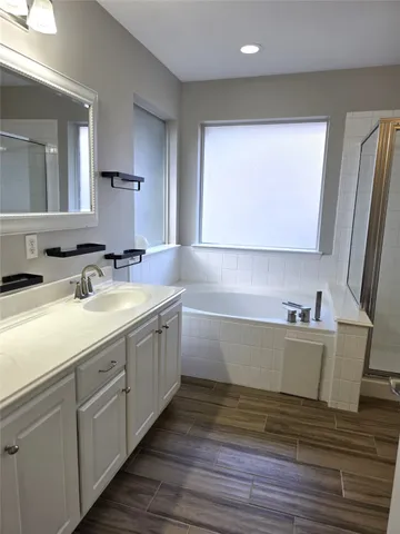 a bathroom with a sink a mirror and a bathtub