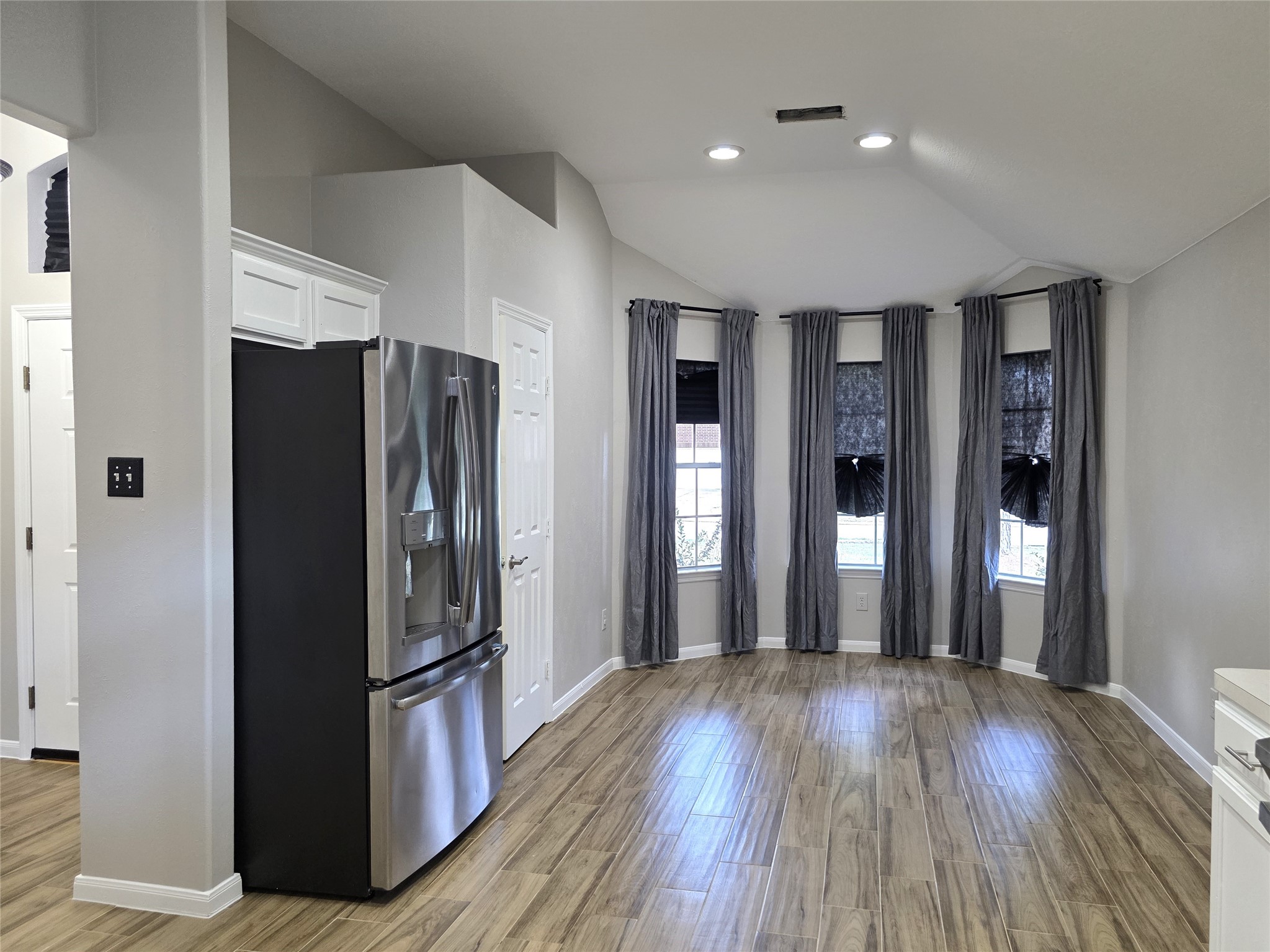 14925 Cypress Ridge Grove Lane Cypress, TX 77429 - Photo 6 of 30 a view of a refrigerator in kitchen and wooden floor