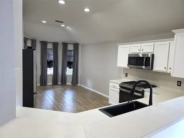 a view of kitchen with furniture and fireplace