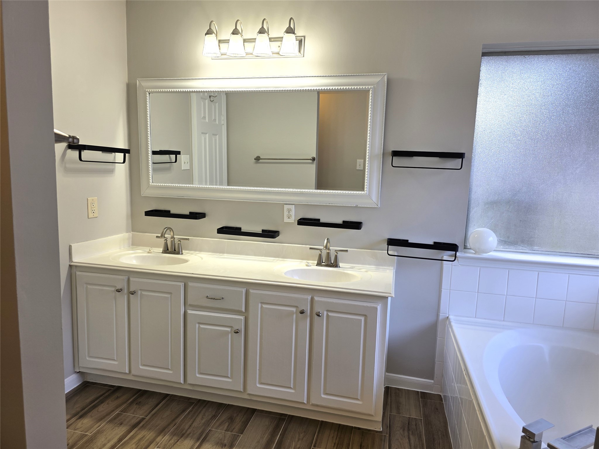 14925 Cypress Ridge Grove Lane Cypress, TX 77429 - Photo 10 of 30 a bathroom with a double vanity sink a mirror and a bathtub