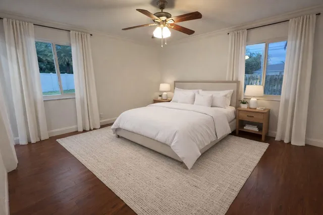 a bedroom with a bed and a chandelier