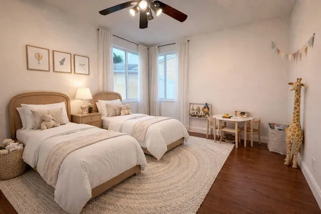 a spacious bedroom with two beds and chandelier