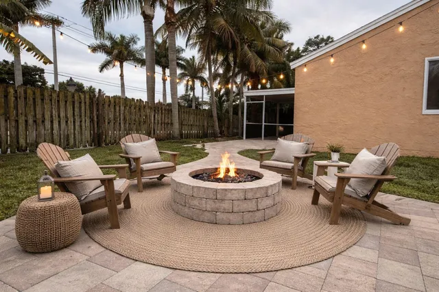 a view of outdoor sitting area with furniture and wooden fence