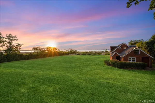 a view of a green field in front of the house