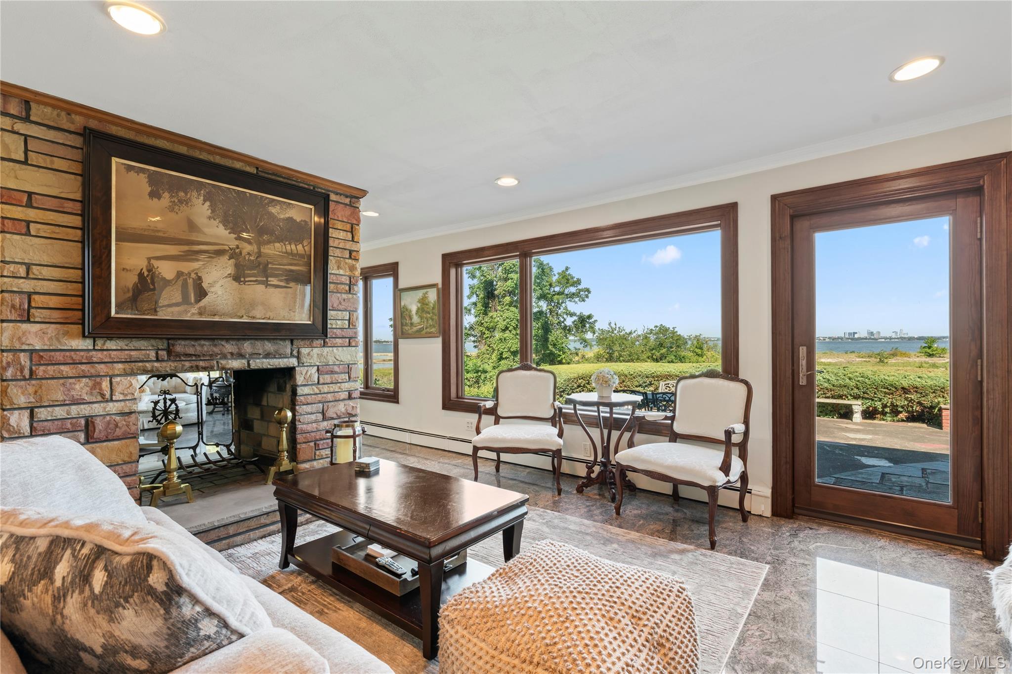 22 Messenger Lane Sands Point, NY 11050 - Photo 15 of 49 a living room with furniture a fireplace and large windows