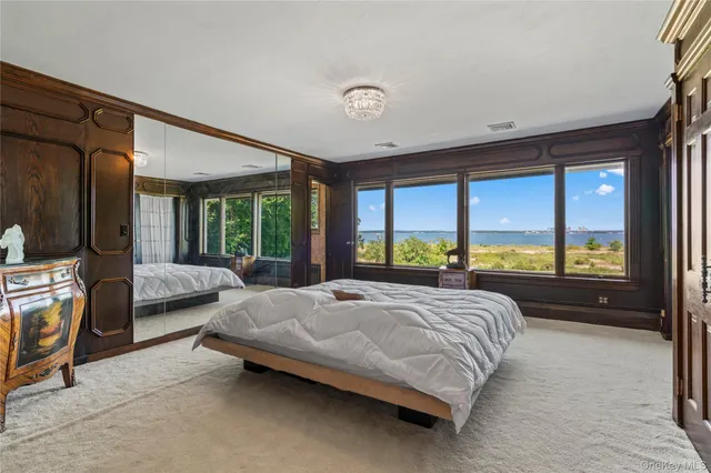 a bedroom with a bed and large window