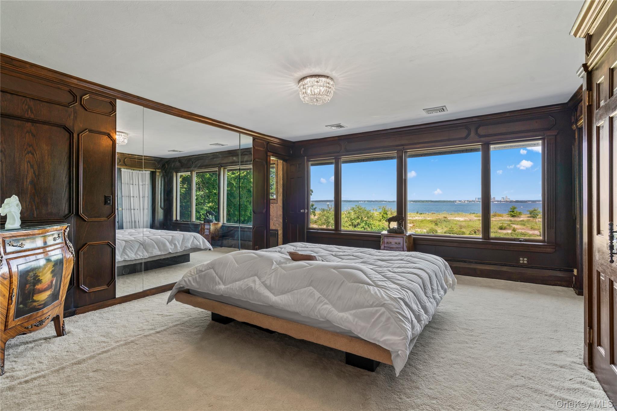 22 Messenger Lane Sands Point, NY 11050 - Photo 21 of 49 a bedroom with a bed and large window