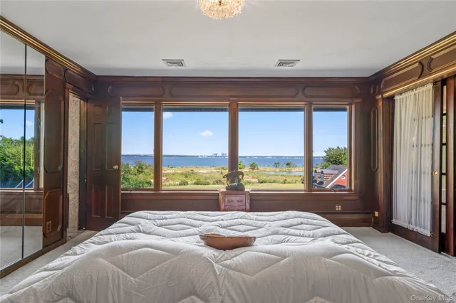 a bedroom with a large bed and a large window