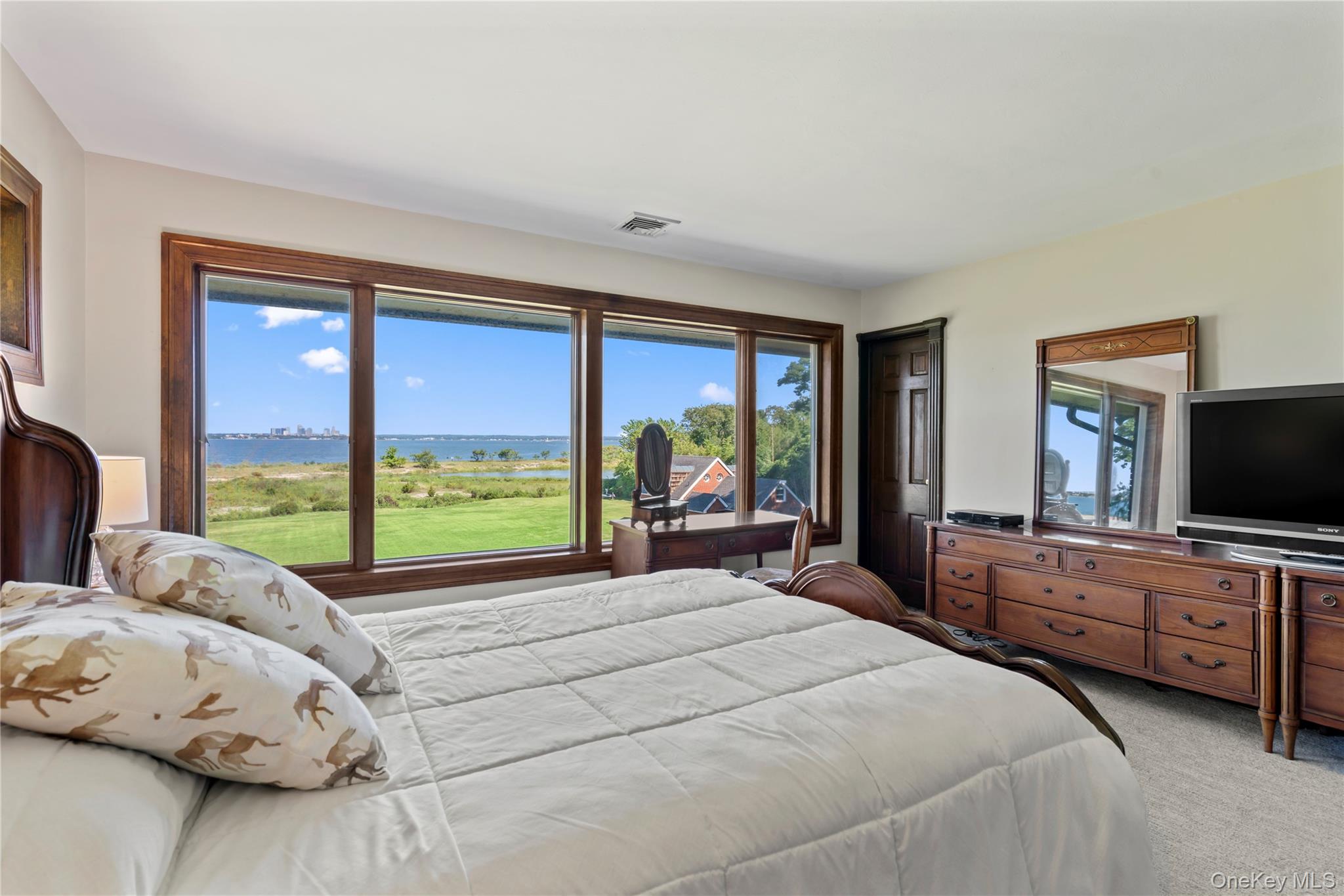 22 Messenger Lane Sands Point, NY 11050 - Photo 28 of 49 a view of a bedroom with furniture and floor to ceiling window