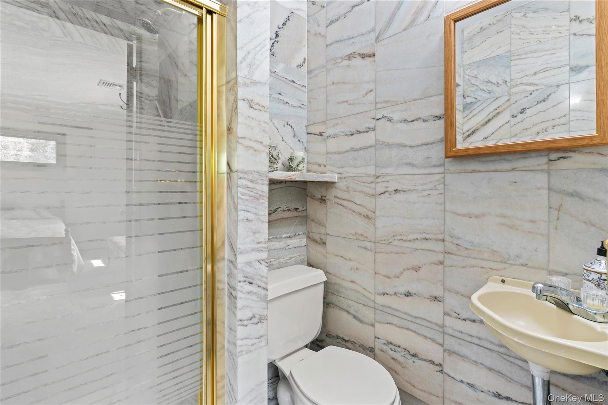 22 Messenger Lane Sands Point, NY 11050 - Photo 29 of 49 a bathroom with a toilet and a sink