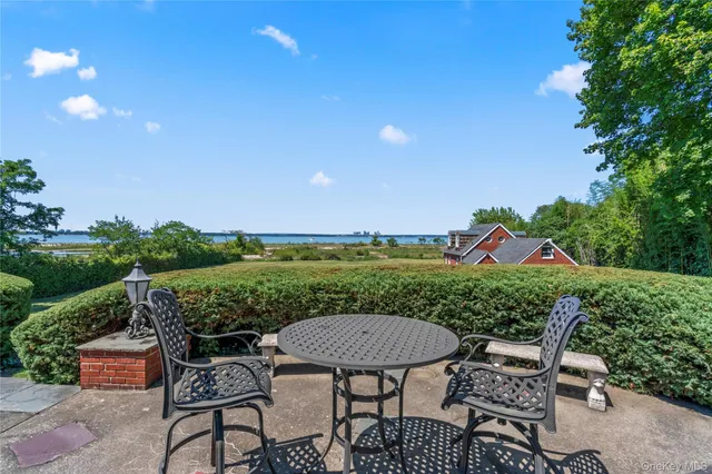 a view of a house with a yard and potted plants
