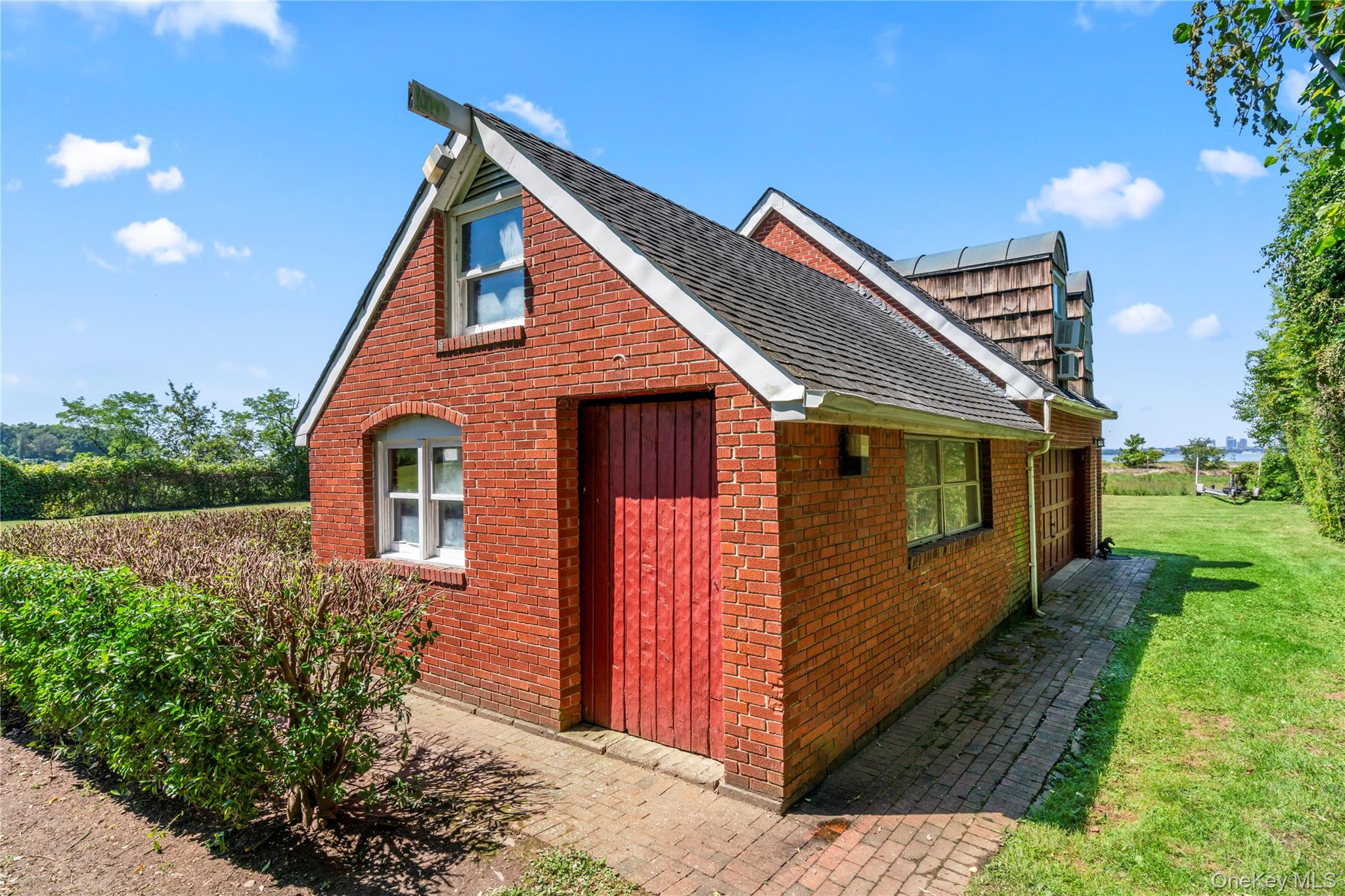 22 Messenger Lane Sands Point, NY 11050 - Photo 35 of 49 a front view of a house with garden