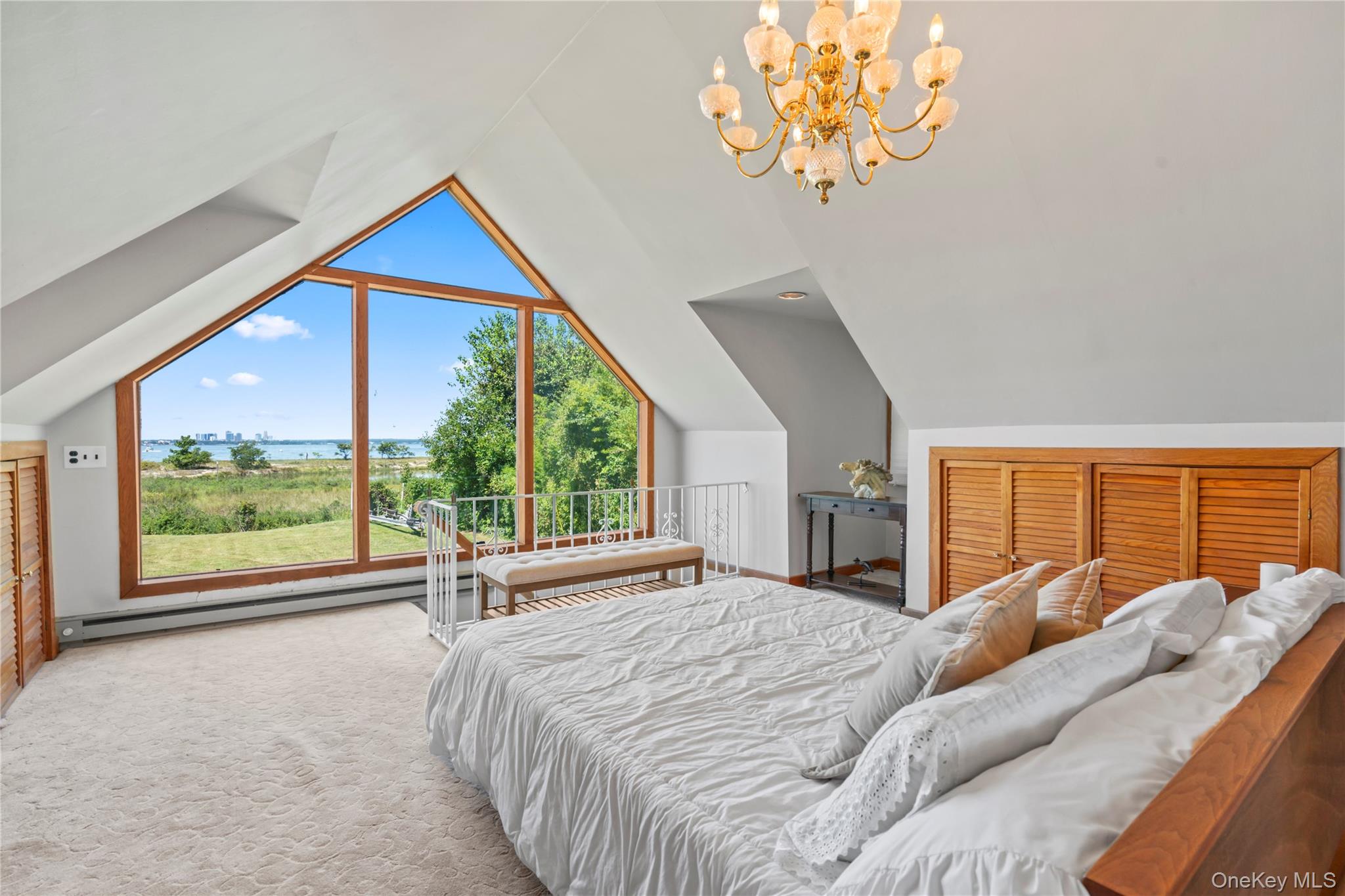 22 Messenger Lane Sands Point, NY 11050 - Photo 36 of 49 a bedroom with a bed and a large window with balcony view