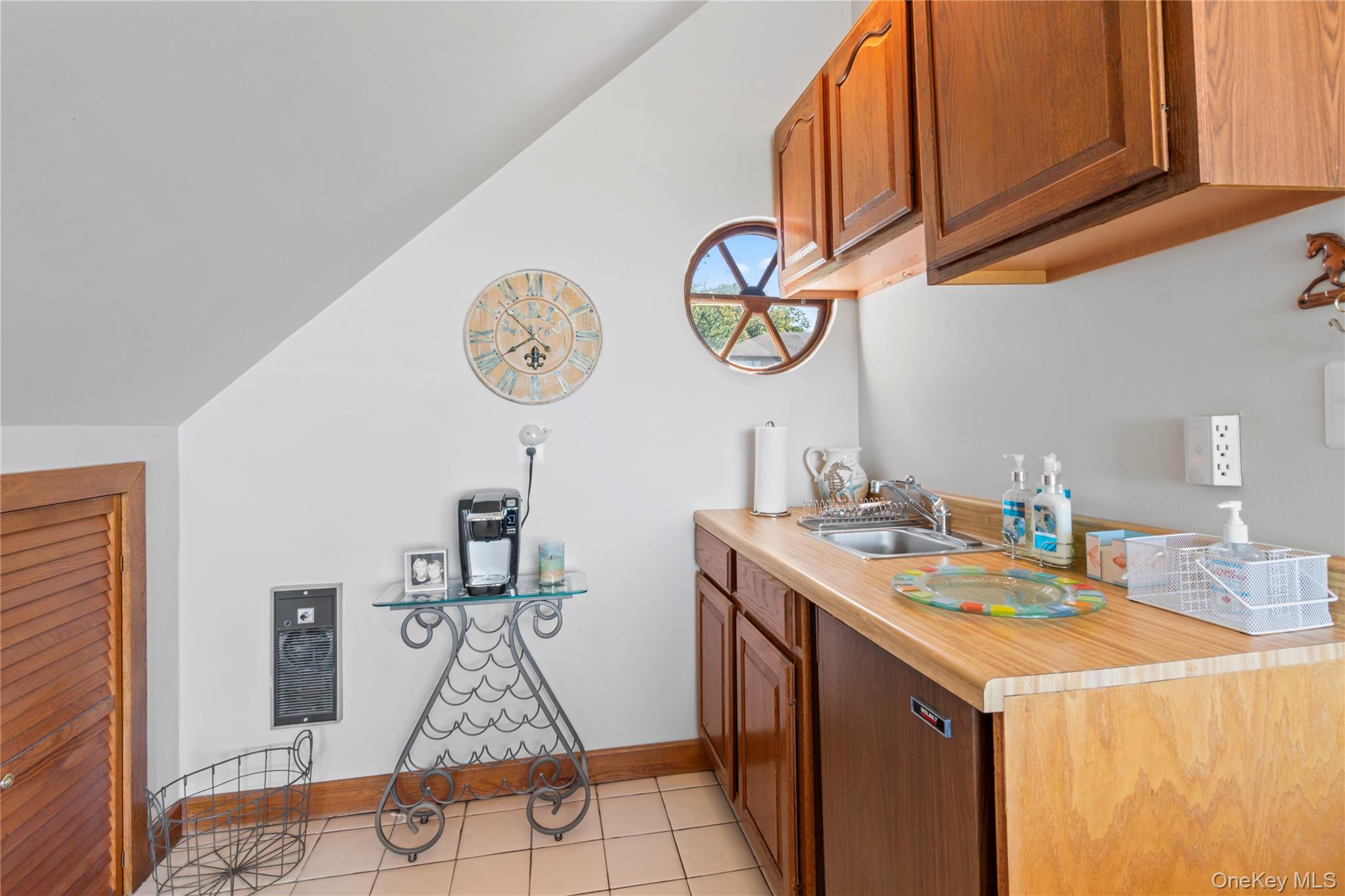 22 Messenger Lane Sands Point, NY 11050 - Photo 37 of 49 a room with a clock and a view of kitchen