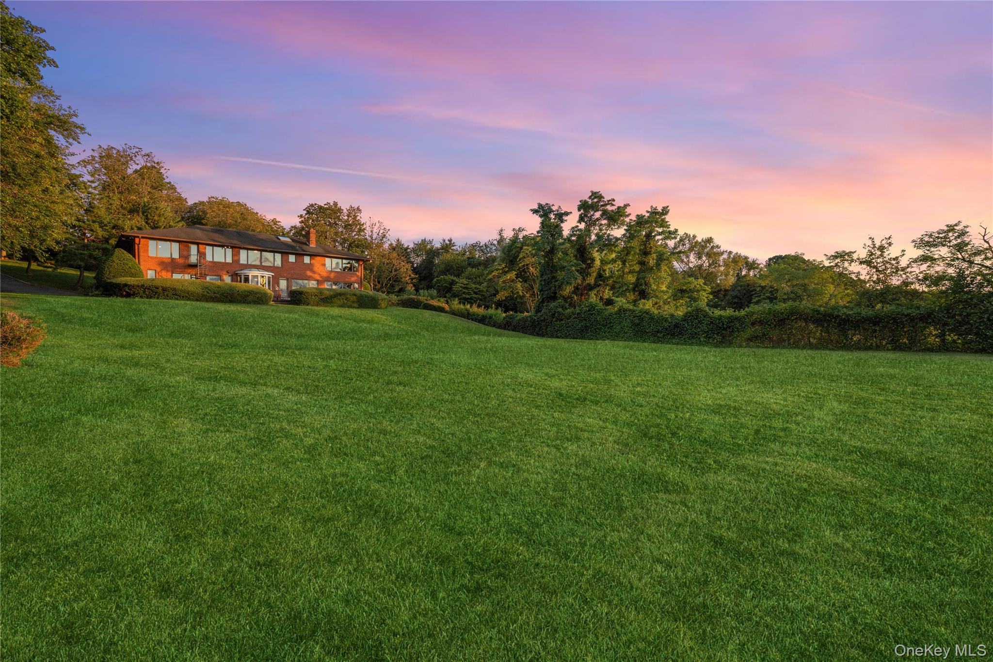 22 Messenger Lane Sands Point, NY 11050 - Photo 6 of 11 a view of a big yard with a house in the background