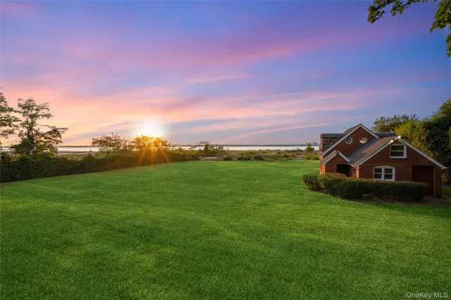 a view of a green field in front of the house