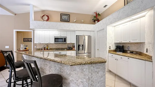 a living room with furniture fireplace and a large window