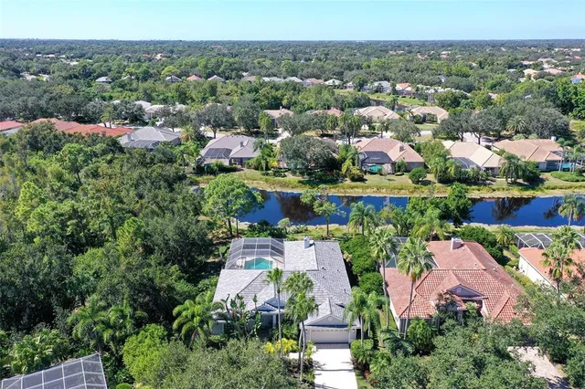 an aerial view of a house with a yard