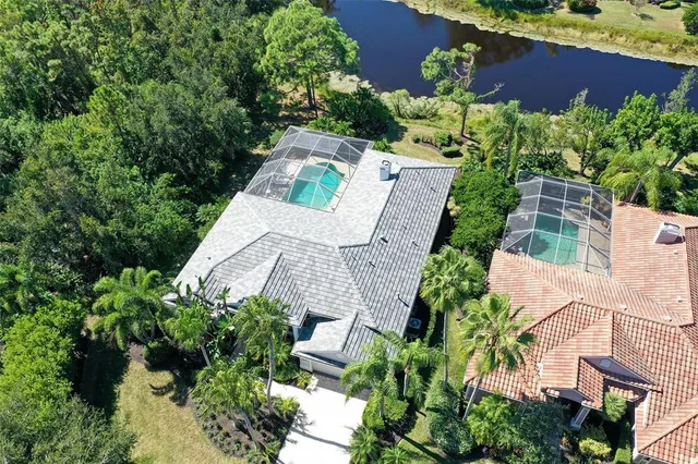 a view of a house with swimming pool and porch with furniture