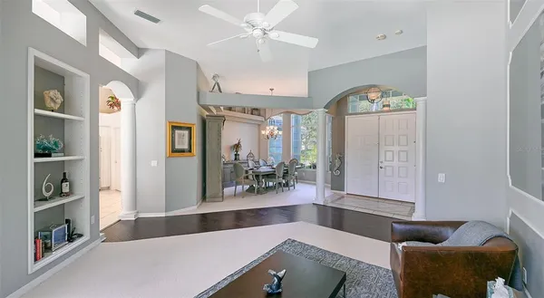 a open kitchen with stainless steel appliances kitchen island granite countertop a table chairs in it and wooden floors