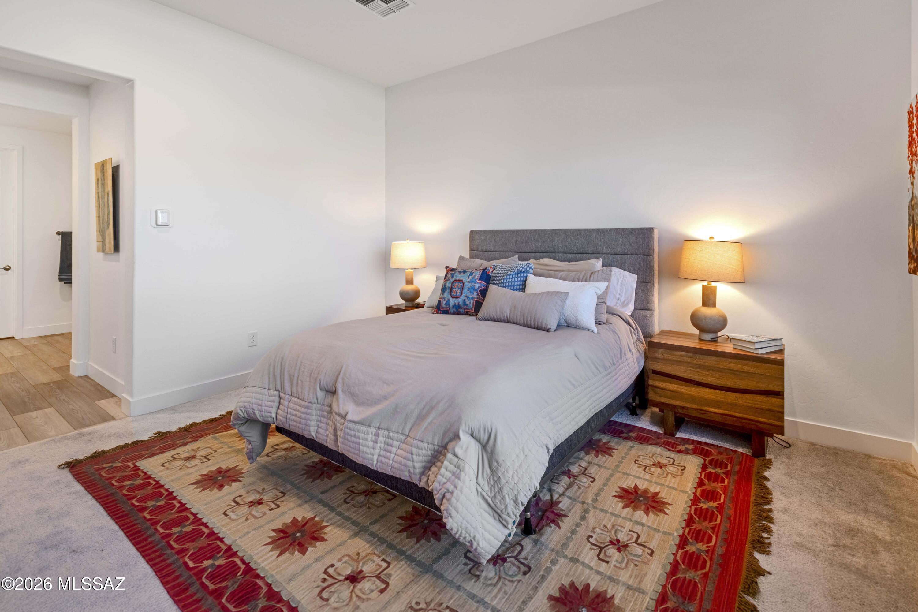 61460 East Shale Road Oracle, AZ 85623 - Photo 19 of 33 a bedroom with a bed and a lamp