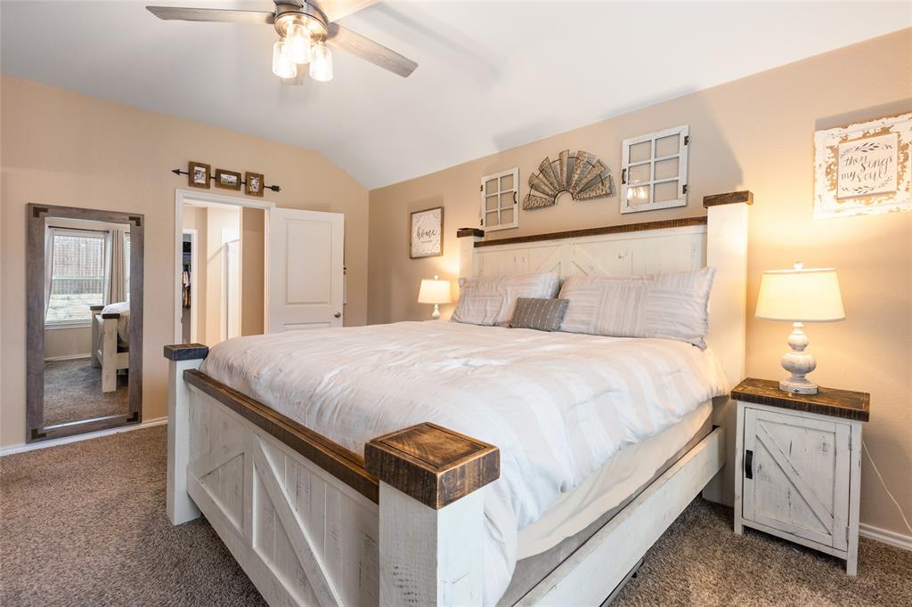 173 Seabiscuit Road Caddo Mills, TX 75135 - Photo 15 of 40 a spacious bedroom with a bed and a chandelier