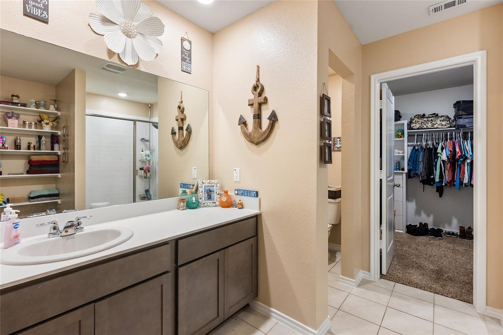 173 Seabiscuit Road Caddo Mills, TX 75135 - Photo 16 of 40 a bathroom with a sink a mirror and a shower