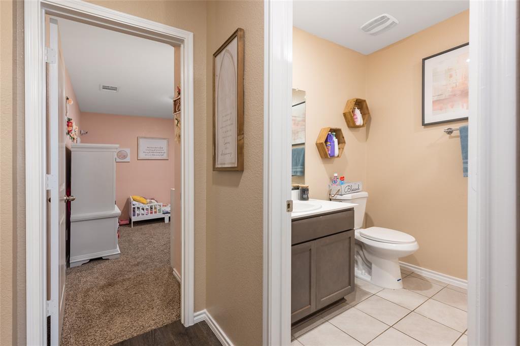 173 Seabiscuit Road Caddo Mills, TX 75135 - Photo 22 of 40 a bathroom with a toilet sink and mirror