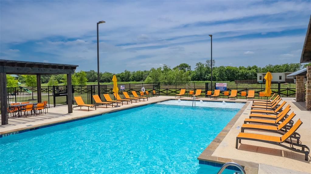173 Seabiscuit Road Caddo Mills, TX 75135 - Photo 38 of 40 a view of a swimming pool with a table and chairs