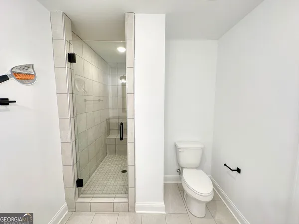 a bathroom with a toilet and a shower