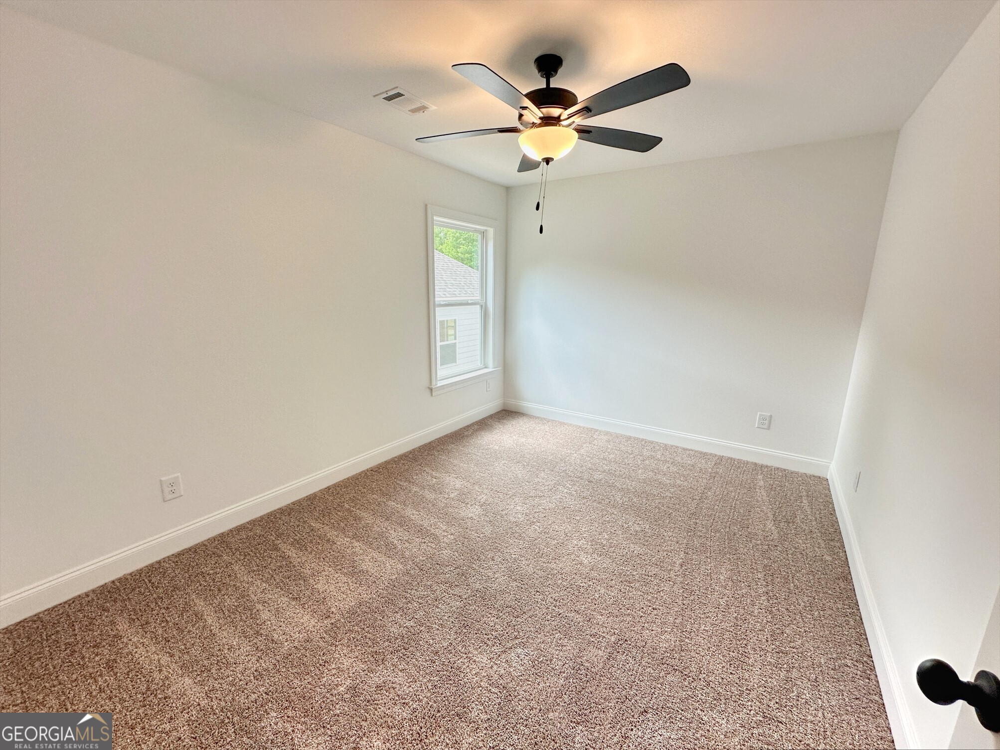 11 River's Edge Lane Franklin, GA 30217 - Photo 13 of 25 an empty room with a window and a fan