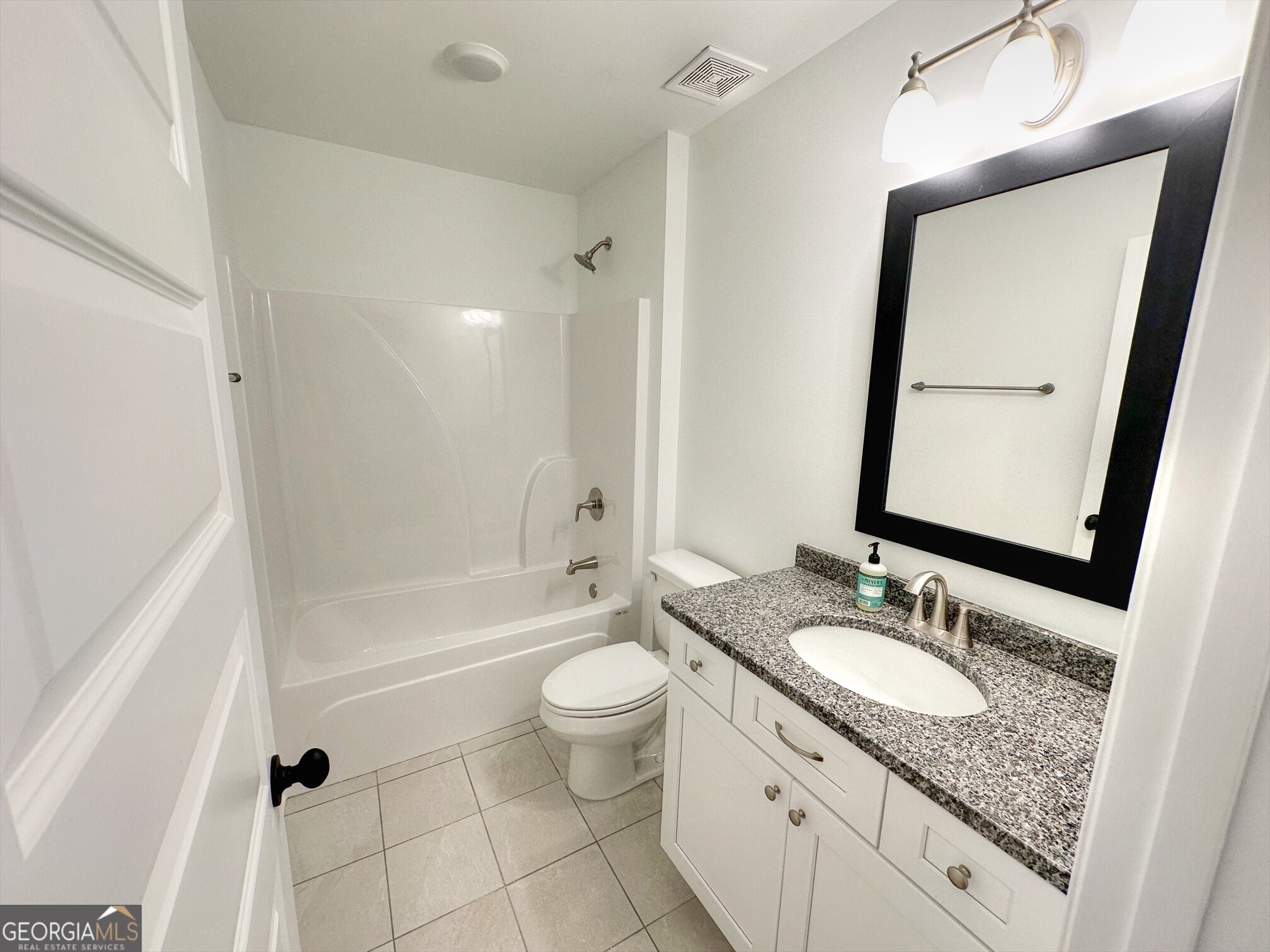11 River's Edge Lane Franklin, GA 30217 - Photo 15 of 25 a bathroom with a granite countertop sink a mirror a bathtub and a toilet