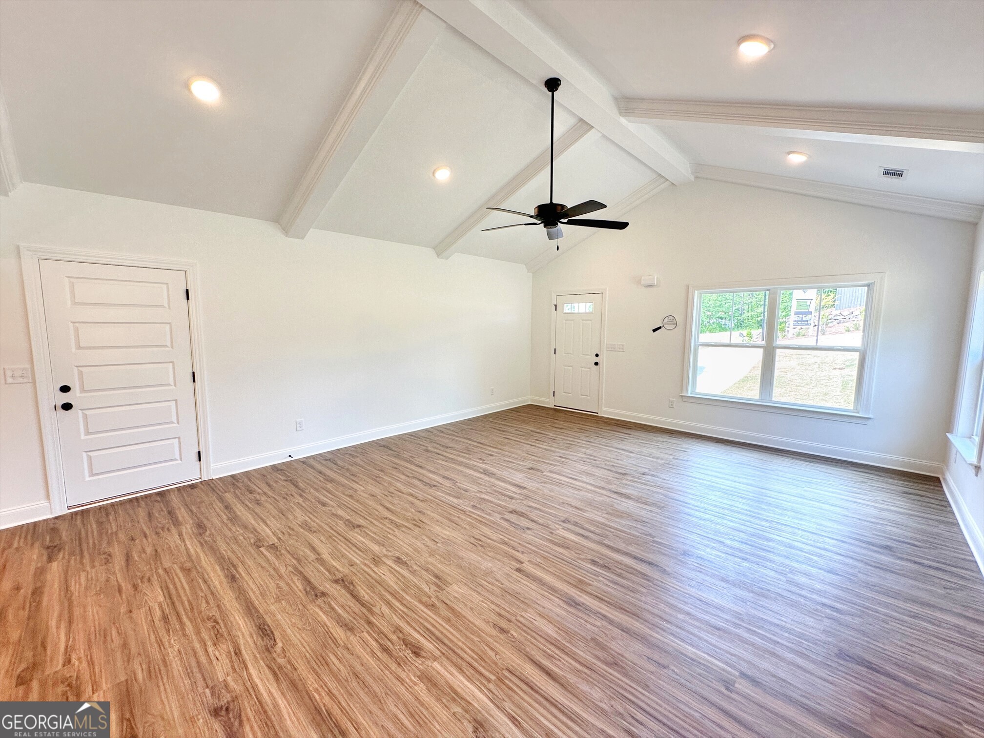 11 River's Edge Lane Franklin, GA 30217 - Photo 3 of 25 an empty room with wooden floor ceiling fan and windows