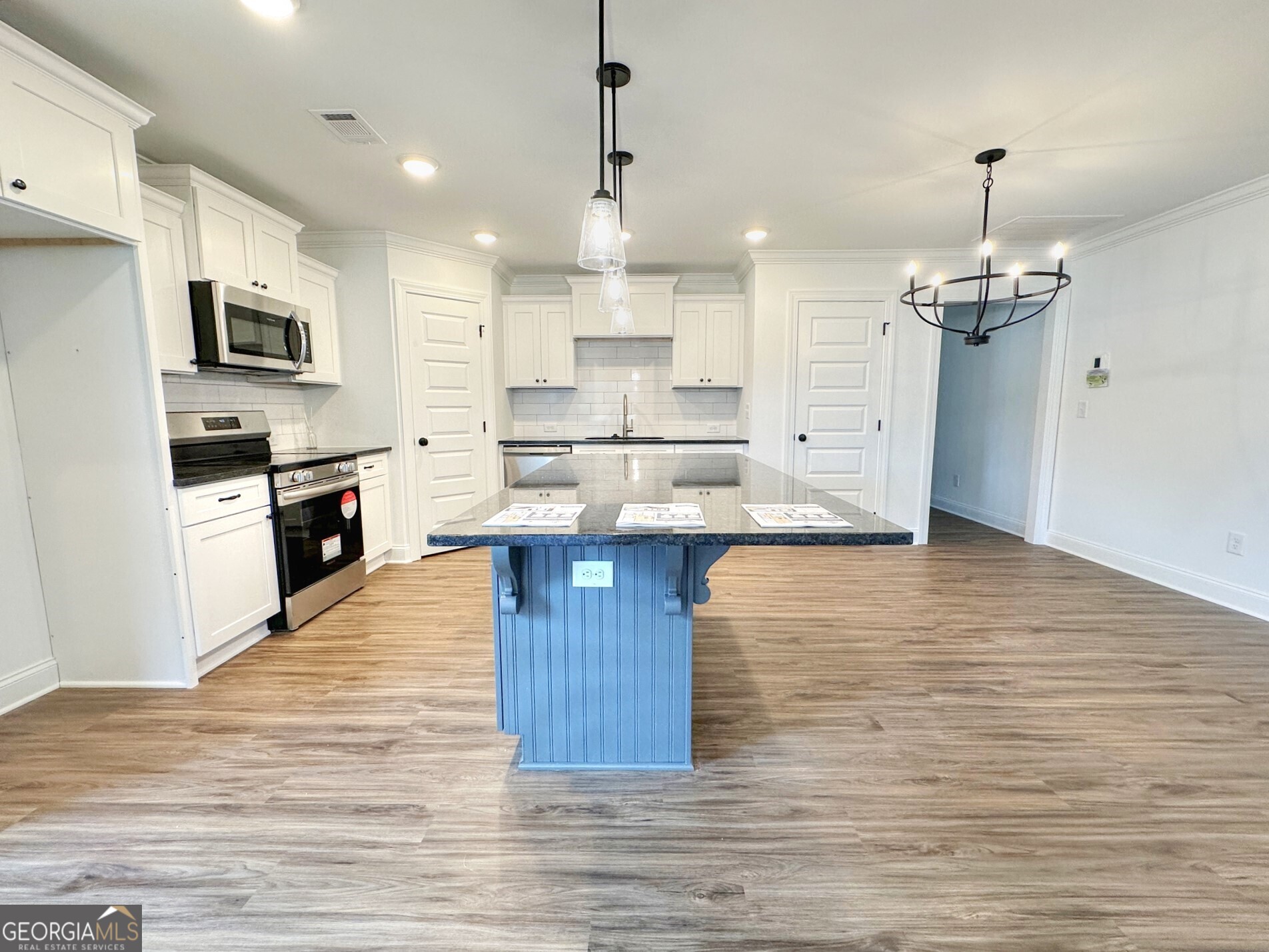 11 River's Edge Lane Franklin, GA 30217 - Photo 6 of 25 a large kitchen with cabinets wooden floor and stainless steel appliances