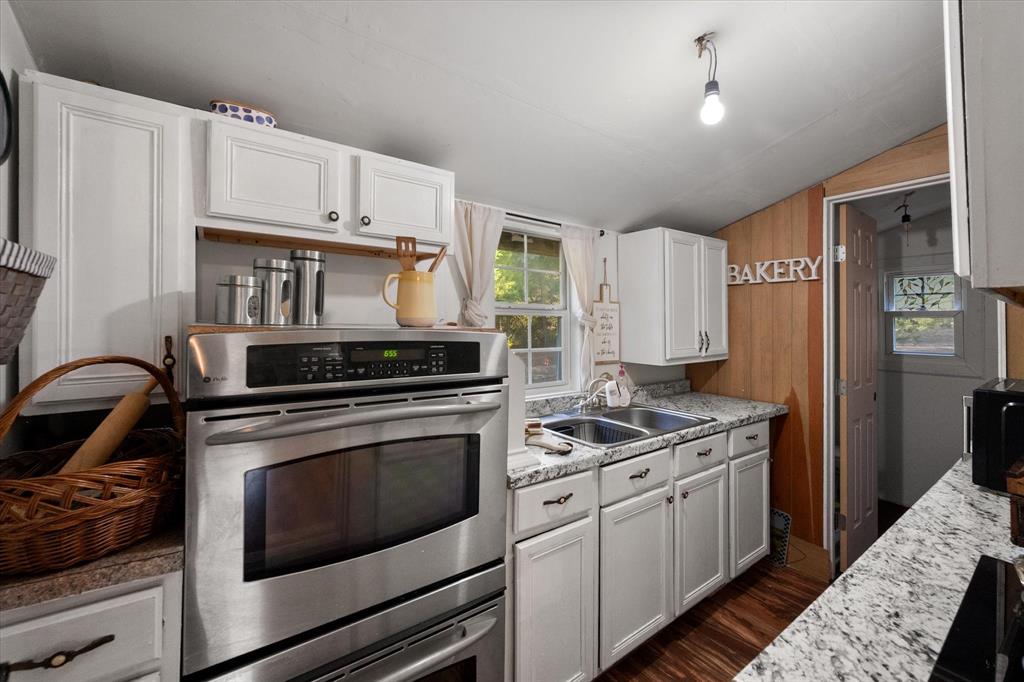 734 Interstate 45 Teague, TX 75860 - Photo 4 of 19 a kitchen with stainless steel appliances granite countertop a stove and a refrigerator