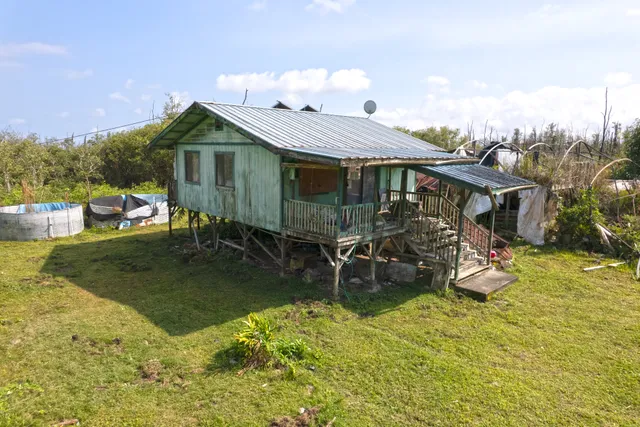 an aerial view of a house with swimming pool garden and patio