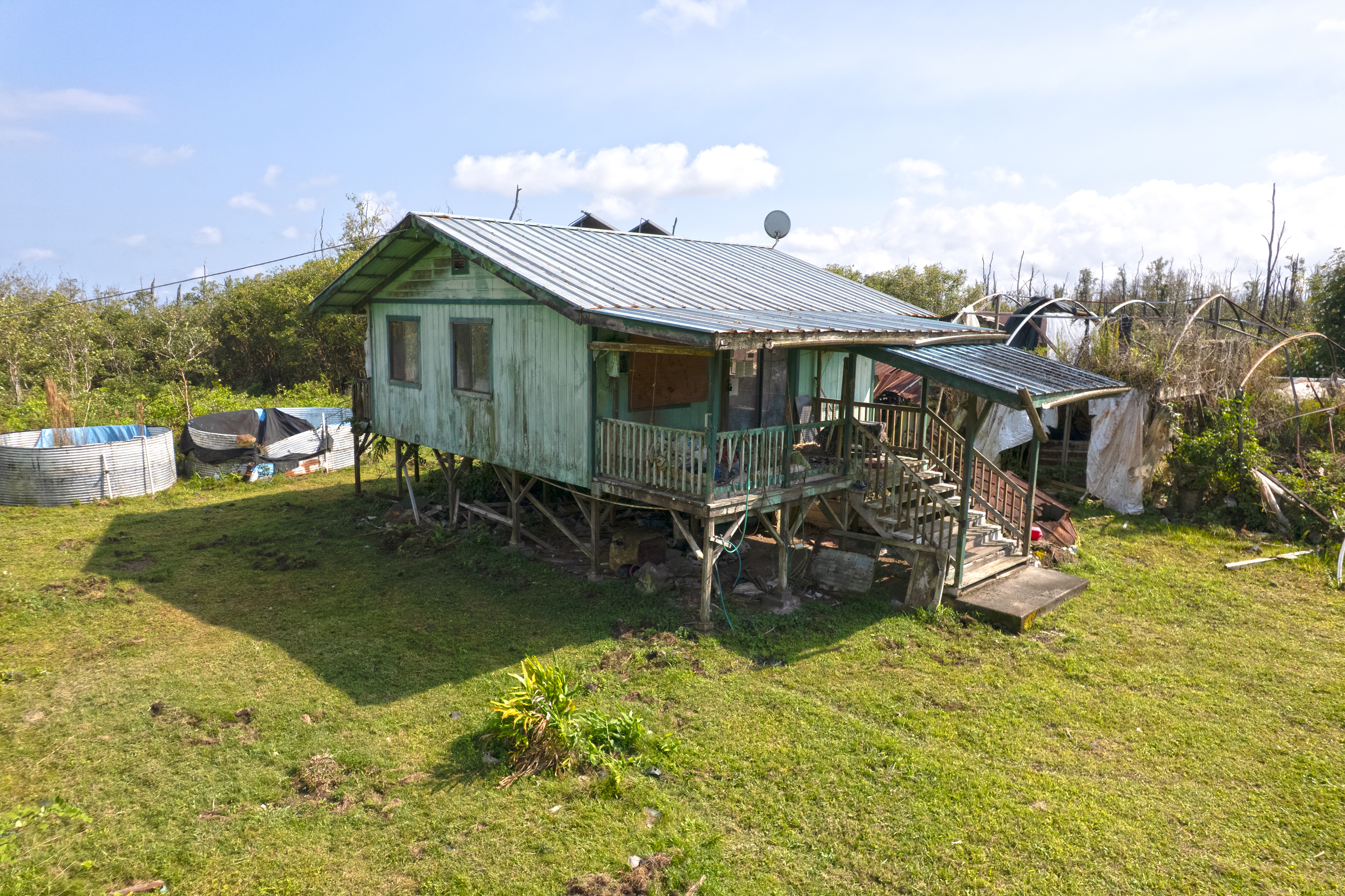 an aerial view of a house with swimming pool garden and patio