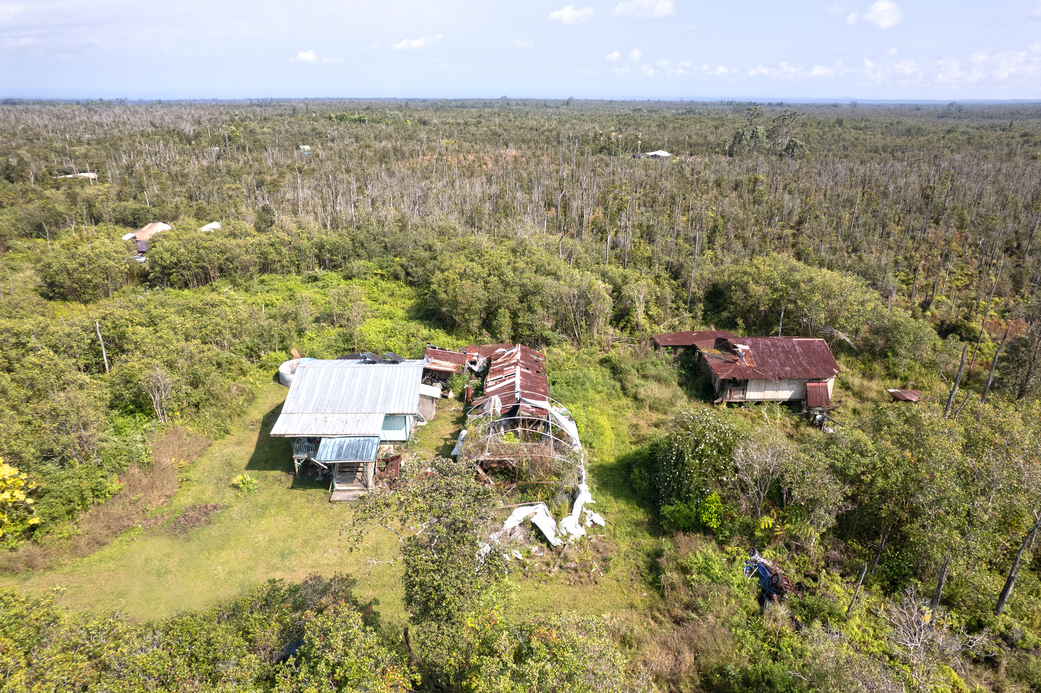 11-2217 Kaleponi Road Mountain View, HI 96771 - Photo 10 of 13 an aerial view of a house with a yard and lake view