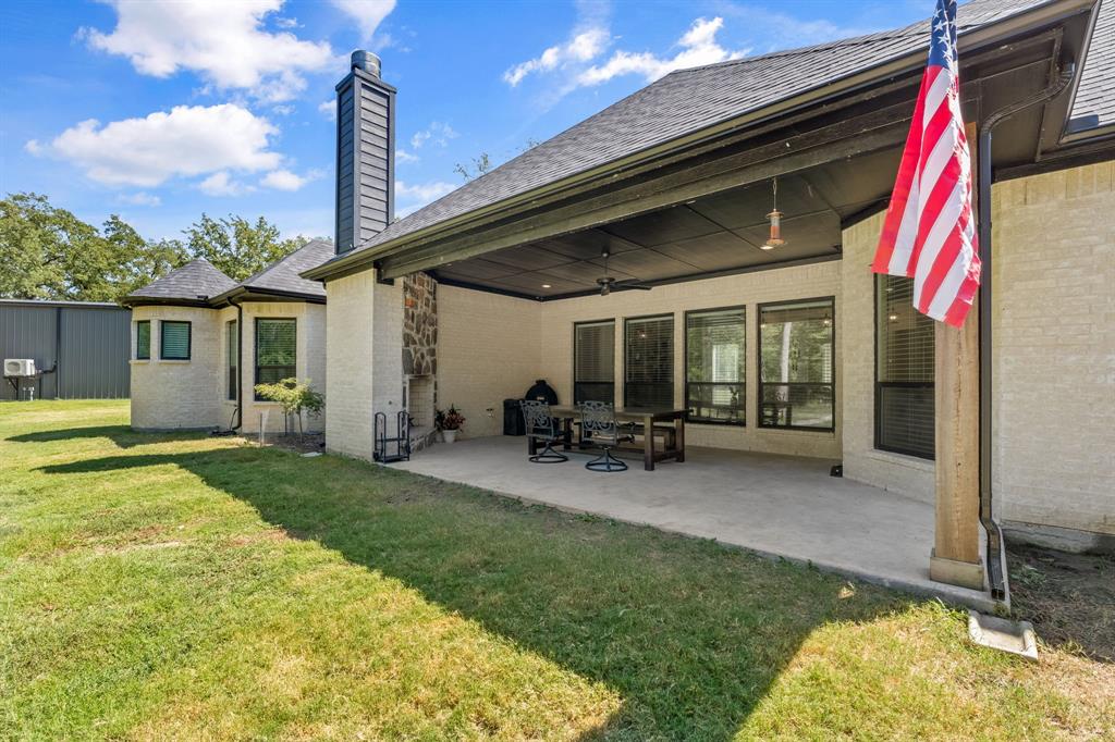 6707 Anchor Quinlan, TX 75474 - Photo 29 of 40 Large covered patio, complete with fireplace and ceiling fans