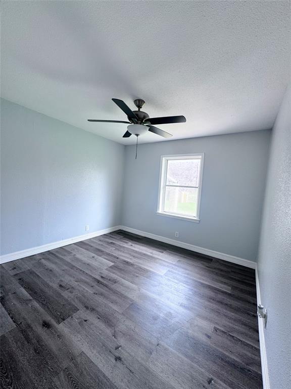 345 16th Street Southwest Paris, TX 75460 - Photo 12 of 15 a view of empty room with wooden floor and fan