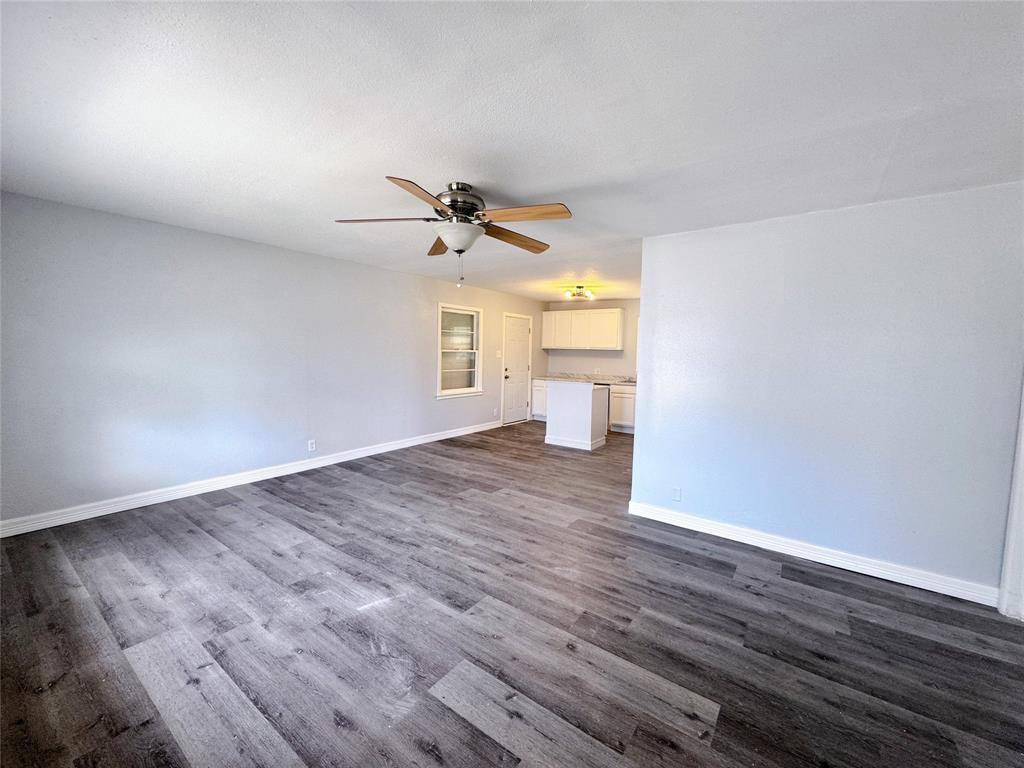 345 16th Street Southwest Paris, TX 75460 - Photo 2 of 15 a view of empty room with wooden floor and fan